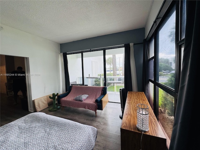 bedroom with hardwood / wood-style floors and a textured ceiling