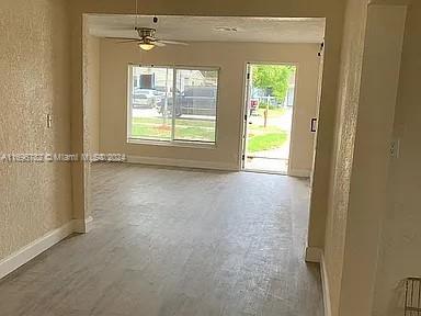 unfurnished room featuring ceiling fan and wood-type flooring