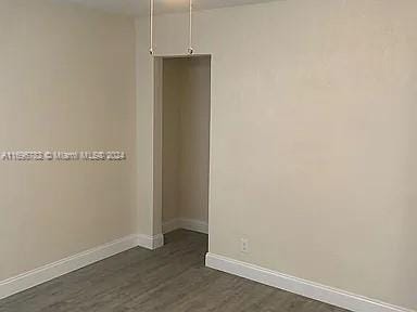 empty room featuring dark wood-type flooring