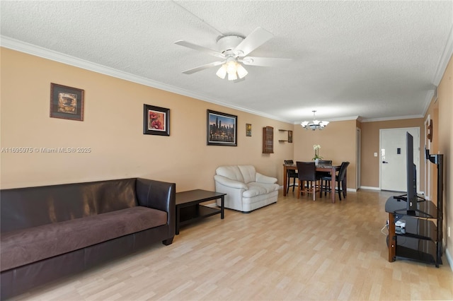 living room featuring a textured ceiling, ornamental molding, ceiling fan with notable chandelier, and light hardwood / wood-style flooring