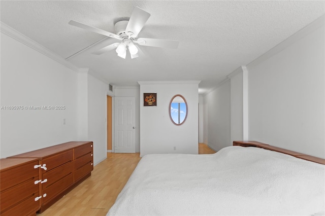 bedroom with a textured ceiling, ceiling fan, crown molding, and light hardwood / wood-style floors