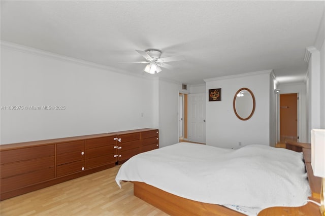 bedroom featuring ceiling fan, light hardwood / wood-style floors, and crown molding