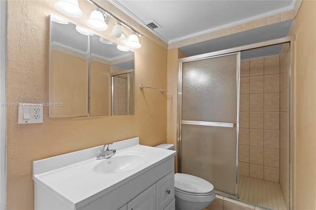 bathroom featuring a shower with shower door, toilet, vanity, and crown molding