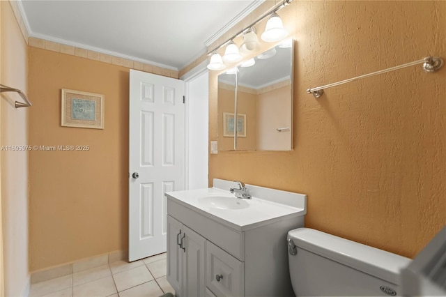 bathroom featuring toilet, ornamental molding, tile patterned flooring, and vanity