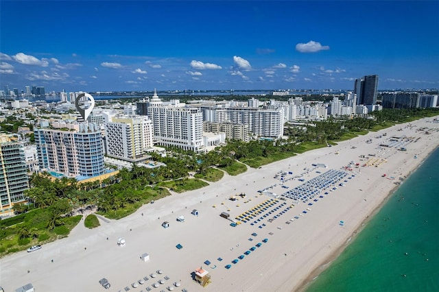 drone / aerial view featuring a view of the beach and a water view