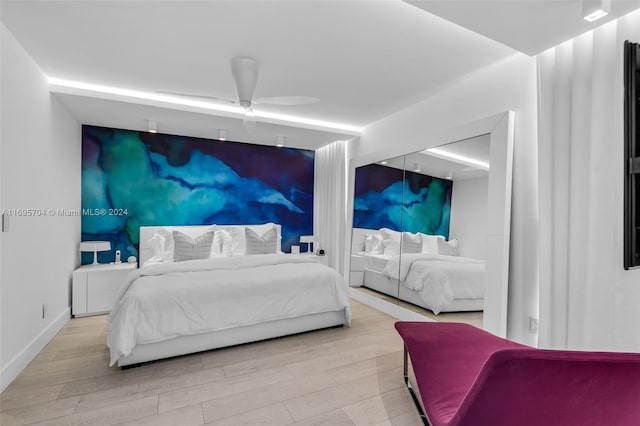 bedroom featuring light wood-type flooring and ceiling fan