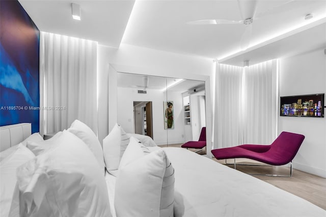 bedroom with ceiling fan, a closet, and light wood-type flooring