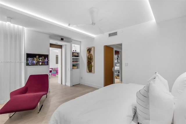 bedroom with ceiling fan and light hardwood / wood-style floors