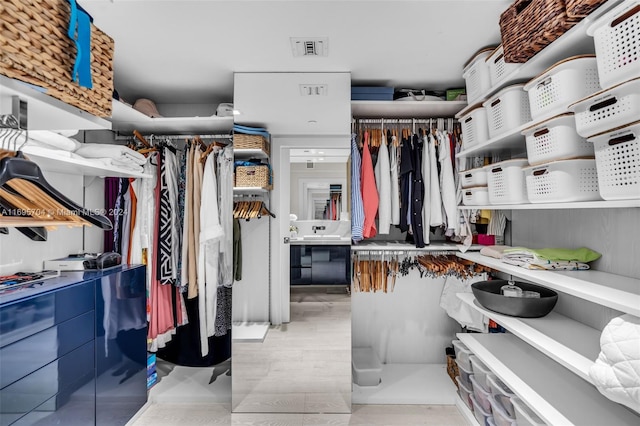 spacious closet featuring light hardwood / wood-style flooring