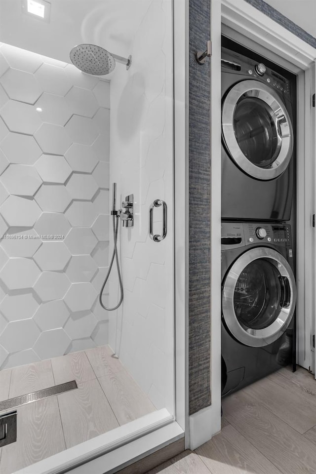 laundry area with light wood-type flooring and stacked washing maching and dryer