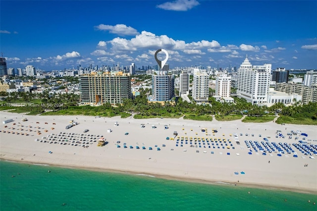 bird's eye view featuring a water view and a view of the beach