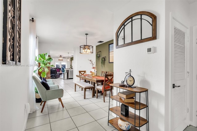 dining area with a notable chandelier and light tile patterned floors