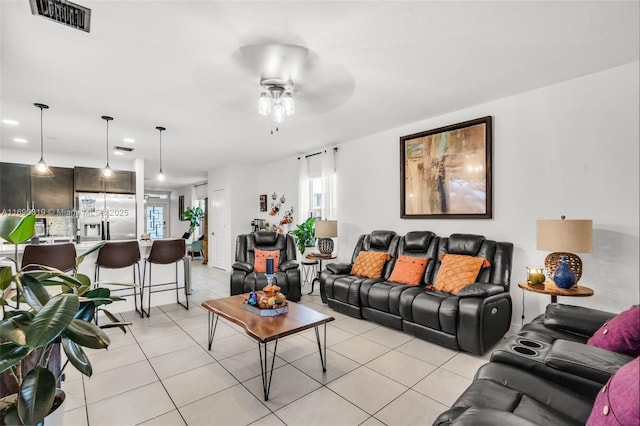 tiled living room featuring ceiling fan