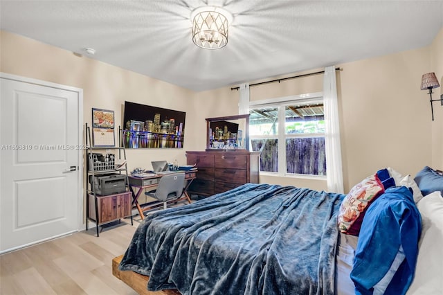 bedroom featuring a textured ceiling and light wood-type flooring