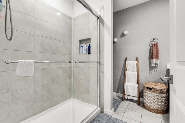 bathroom with walk in shower and tile patterned flooring