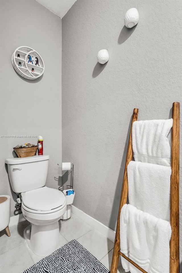 bathroom featuring tile patterned flooring and toilet