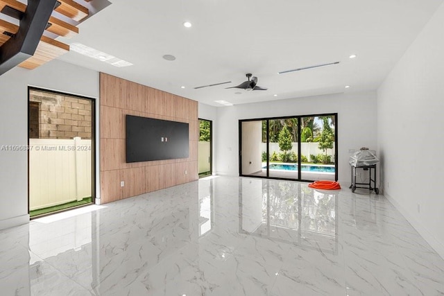 unfurnished living room featuring ceiling fan