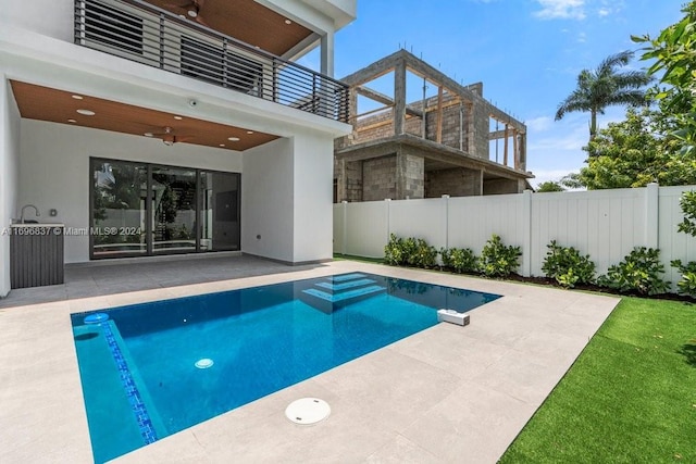 view of pool featuring ceiling fan and a patio