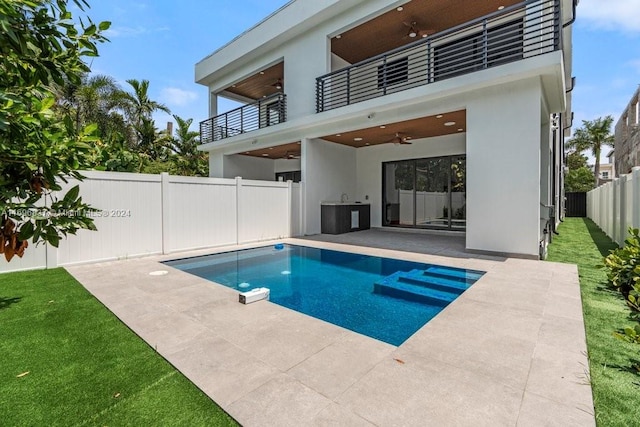 view of pool featuring ceiling fan and a patio