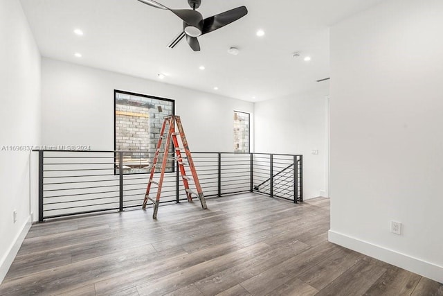 empty room with ceiling fan and dark hardwood / wood-style flooring