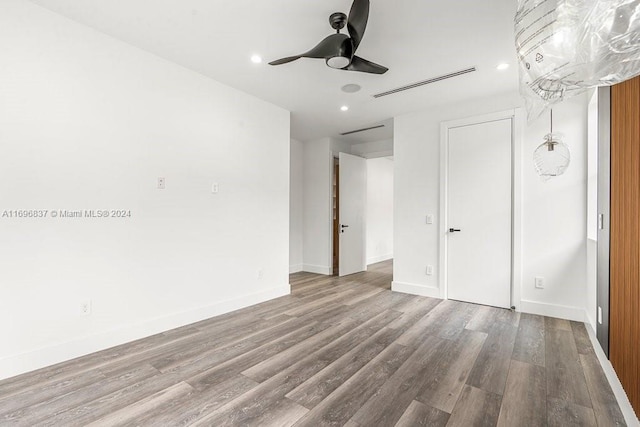 unfurnished bedroom featuring ceiling fan and hardwood / wood-style flooring