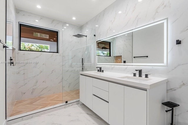 bathroom with tiled shower, vanity, and tile walls