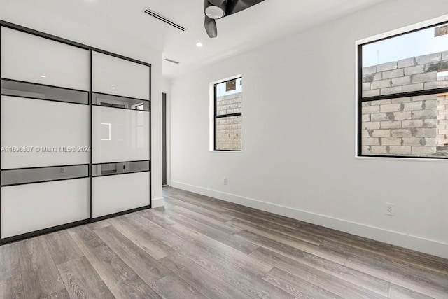 unfurnished bedroom featuring ceiling fan and light wood-type flooring