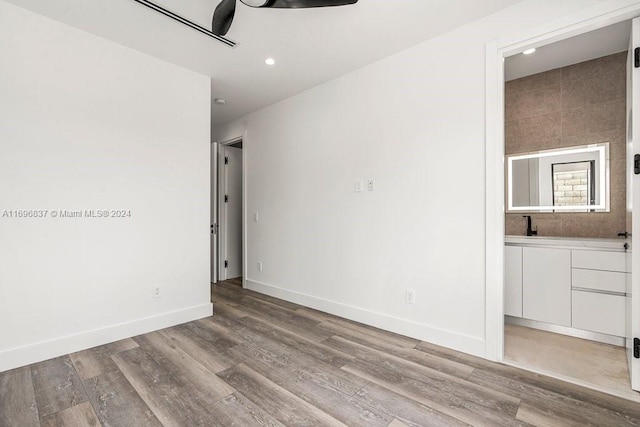 spare room featuring light hardwood / wood-style flooring and sink