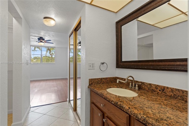 7100 NW 17th St Unit 219, Plantation, FL 33313 - bathroom featuring vanity, tile patterned floors, a textured ceiling, baseboards, and ceiling fan
