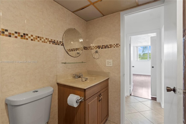 7100 NW 17th St Unit 219, Plantation, FL 33313 - half bathroom featuring tile walls, vanity, tile patterned floors, and toilet