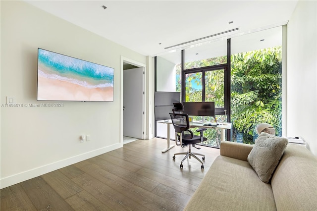 office space with hardwood / wood-style floors and expansive windows