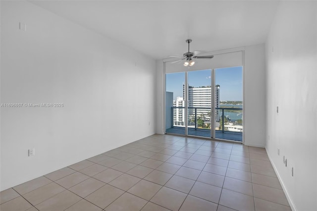 spare room with light tile patterned floors and ceiling fan