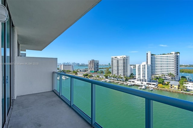 balcony with a water view and a city view