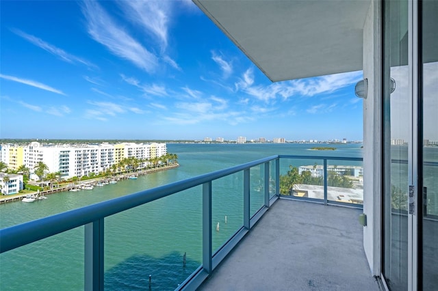 balcony with a water view and a city view