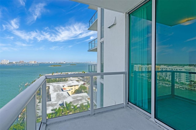 balcony featuring a view of city and a water view