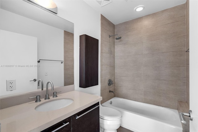 bathroom with visible vents, vanity, toilet, and shower / tub combination