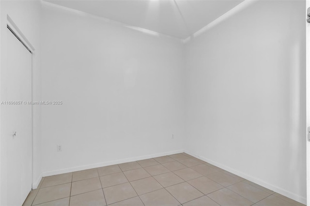 unfurnished room featuring baseboards