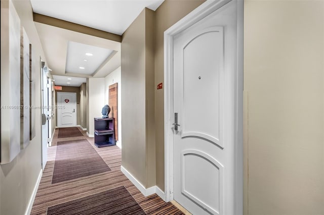 hallway with recessed lighting, baseboards, and carpet