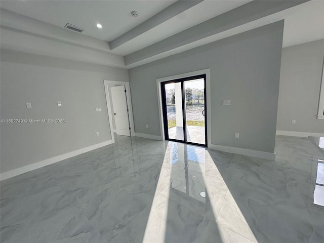 empty room with a raised ceiling