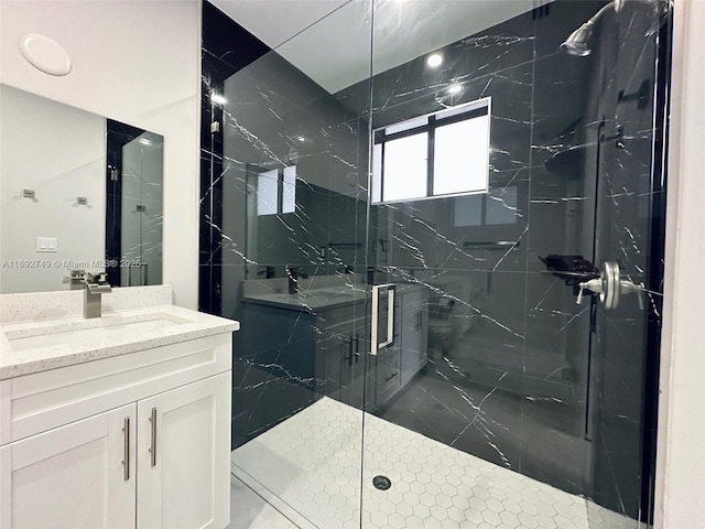 bathroom featuring vanity and a shower with shower door