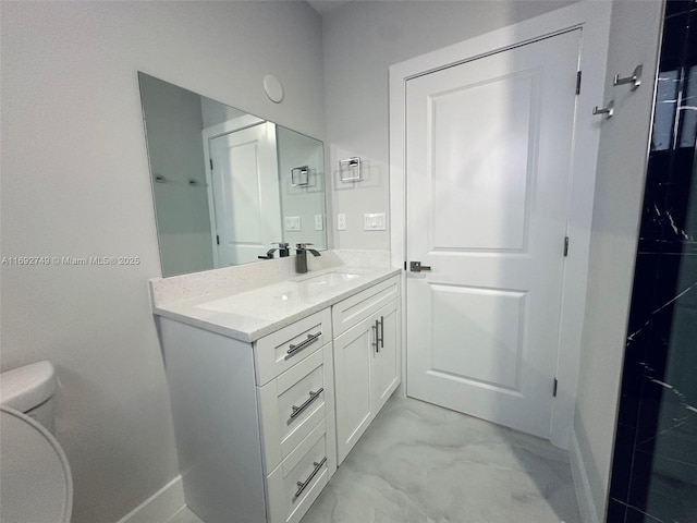 bathroom featuring vanity and toilet