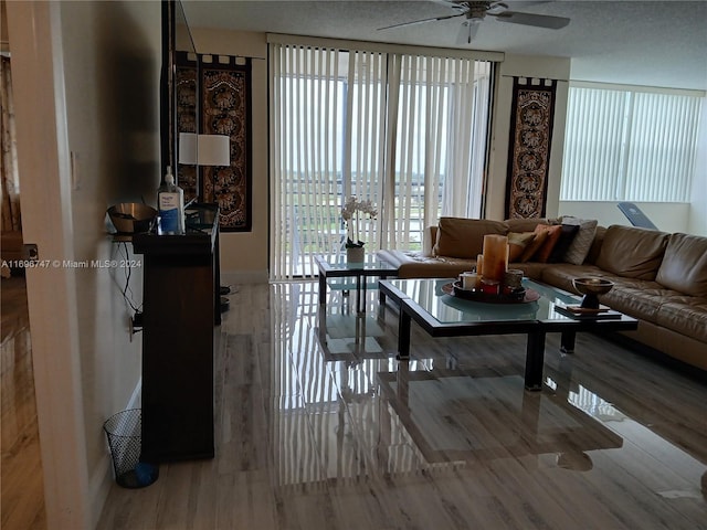 living room featuring ceiling fan and hardwood / wood-style floors