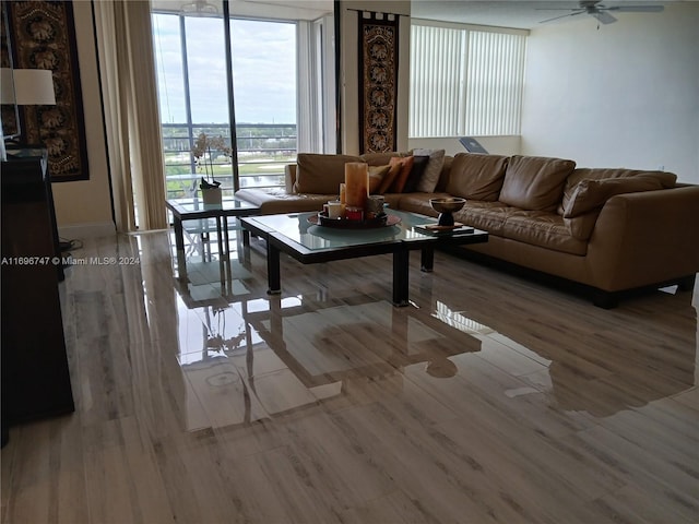 living room with floor to ceiling windows, ceiling fan, and hardwood / wood-style floors