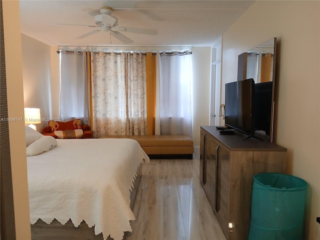 bedroom with light hardwood / wood-style flooring and ceiling fan