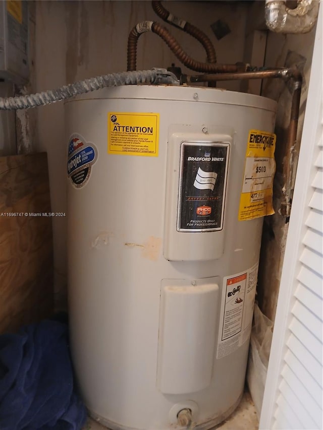 utility room with electric water heater