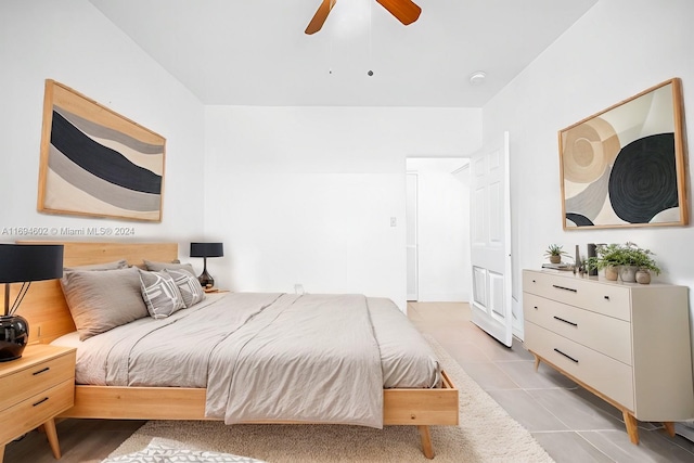 bedroom with ceiling fan and light tile patterned floors