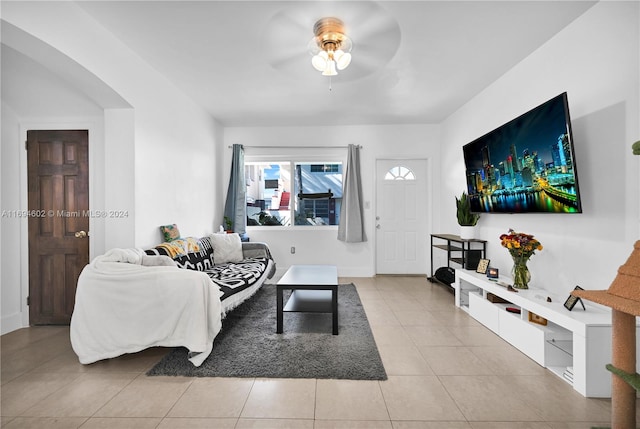 tiled living room featuring ceiling fan