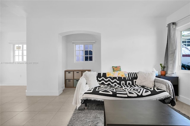 bedroom featuring multiple windows and light tile patterned flooring