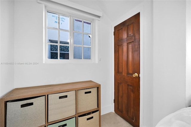 entrance foyer with lofted ceiling and light tile patterned floors