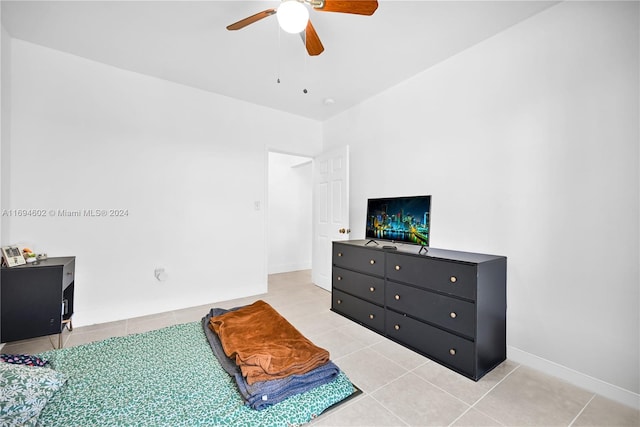 tiled bedroom featuring ceiling fan